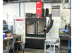 Machining center in a workshop with various equipment and tools.